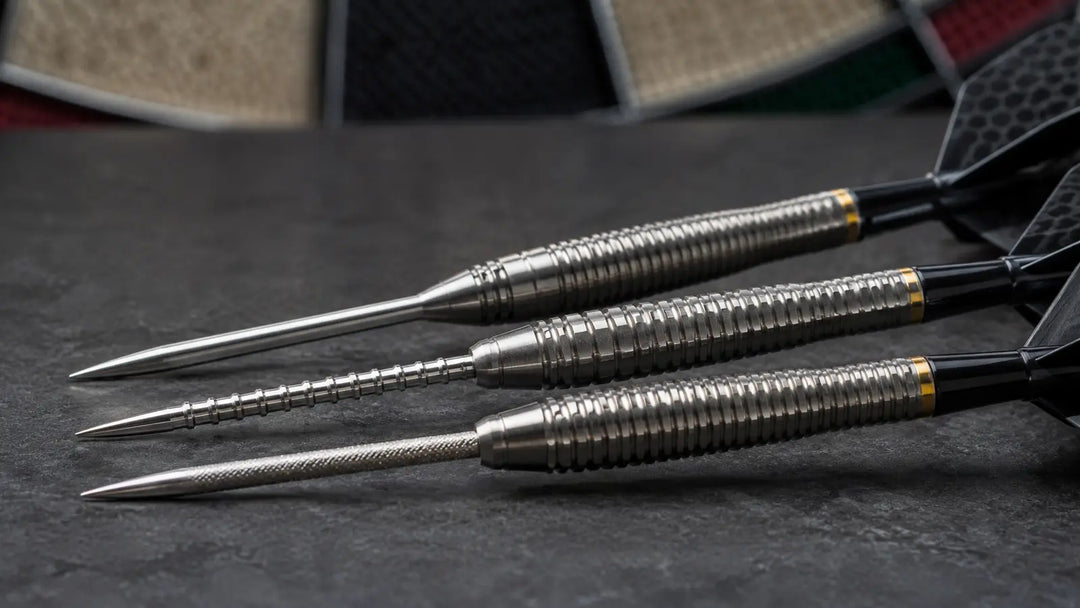 Close-up of three darts with long steel points and textured barrels