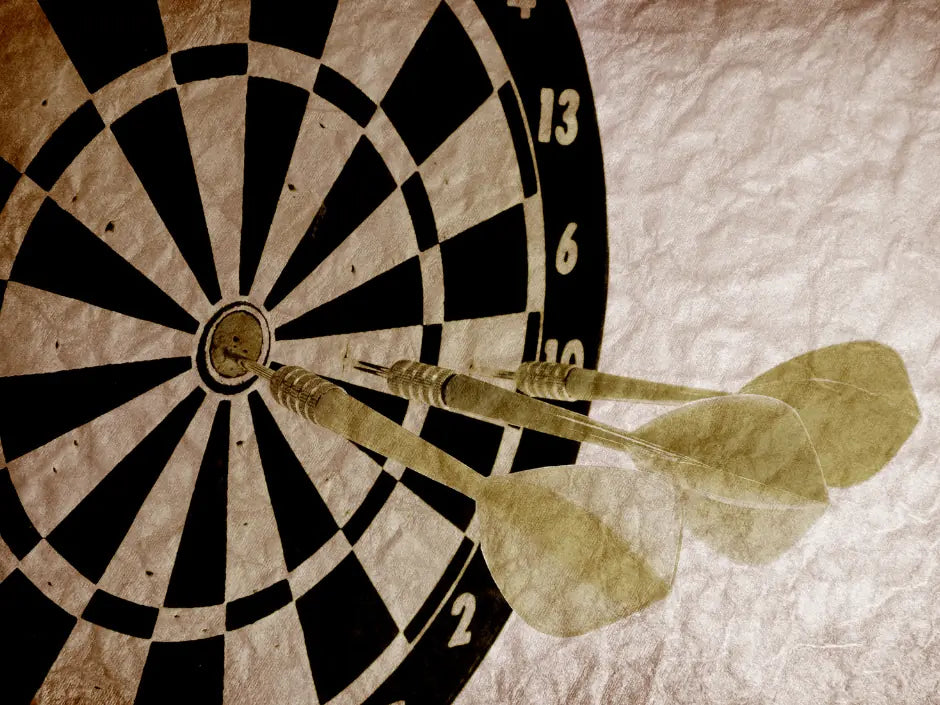 Two darts with translucent Condor Axe flights in a dartboard
